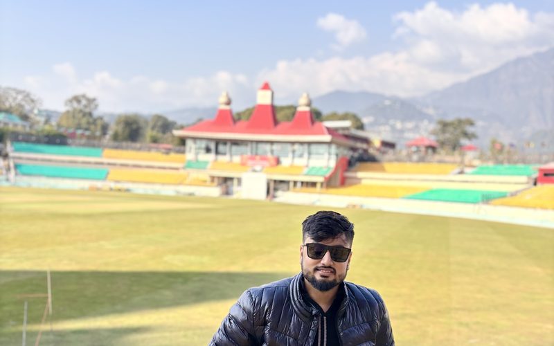 Deep Halder at the HPCA cricket stadium in Dharamshala, Himalayas behind